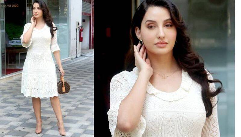 Nora Fatehi in a white dress and luxurious bag