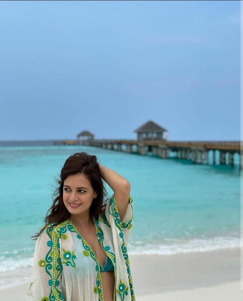 She looked very elegant and pretty wearing the beach couture. She wore a green and white front open kaftan jacket with a bikini bra. On the other day, she chose a white long gown and paired it with sunnies and a hat. The caption of the pictures read, "The Indian Ocean and the incredible people at @TravelWithJourneyLabel @jamanafaru_maldives beckoned and here we are, in absolute paradise Enjoying the most INCREDIBLE hospitality Every moment here so far has been pure joy Thank you @divyabydivyaanand for this handcrafted beauty. Styled by @theiatekchandaney, assisted by @jia.chauhan."
