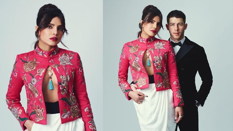 It was like a 'date-night' for the couple, and Priyanka Chopra turned heads in her daring hot-pink outfit. She chose to wear a floral embroidered blazer with a front-opening shirtless. She paired the blazer with white high-waisted billowing trousers and completed the outfit with black pumps with stockings.