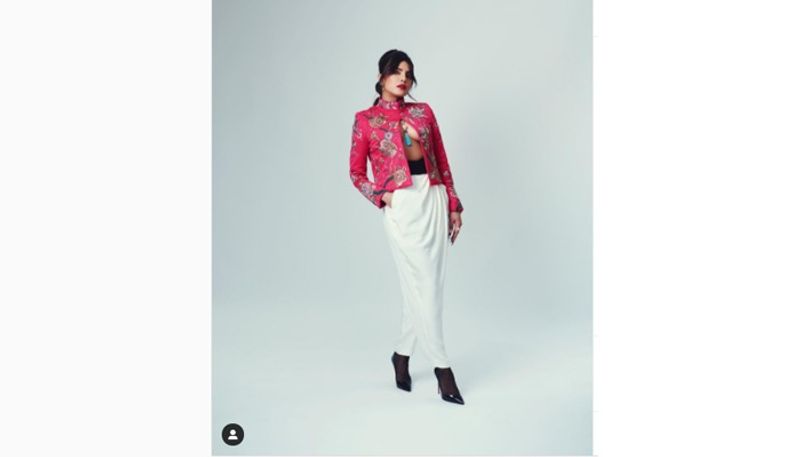 The blazer came from Spanish label Pertegaz's Fall/ Winter runway collection. She featured two of the most popular fashion trends, a black-tip French manicure and a bubble braid. She rounded off her look with Bulgari accessories, and her bangs gave an edge to her bubble braided look.