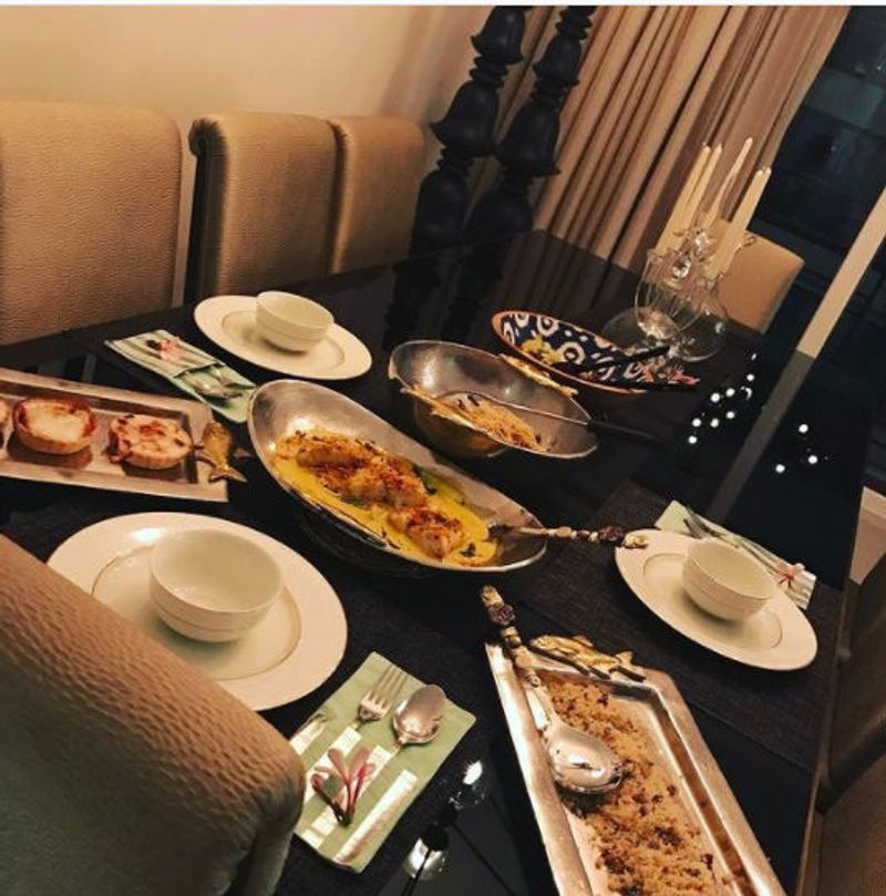 Her dining table is just an extension of the living room. Dining table is a huge wooden table, and the room has beige brown oversized chairs.