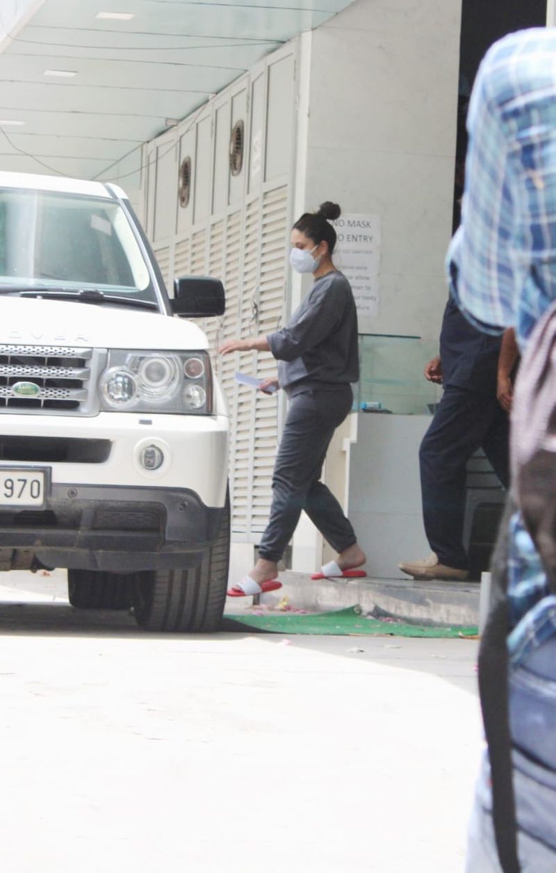 Bebo hair tied up in a bun, and she was wearing red flip flops.