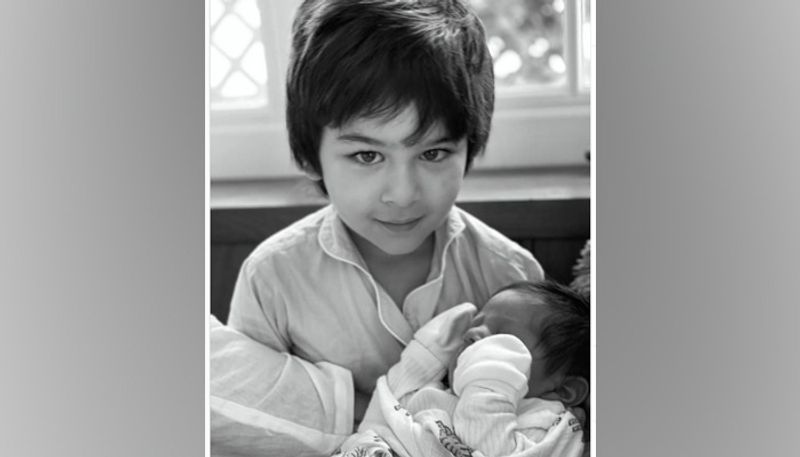 Sharing a picture of her baby in her elder son Taimur Ali Khan's arms.