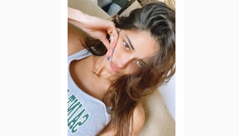 In the pictures, we can see Ananya is wearing a simple racerback, and open locks. 