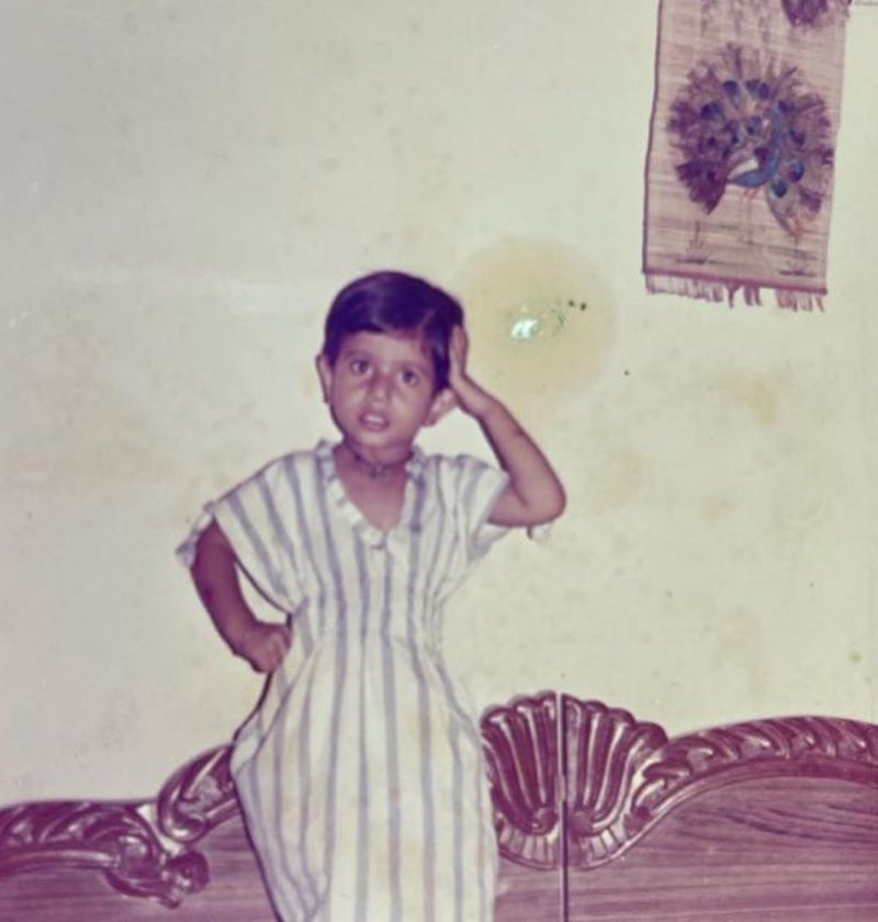 While here, Chahal gives a pose for the camera, apparently dancing, as he wears a white striped one-piece dress.