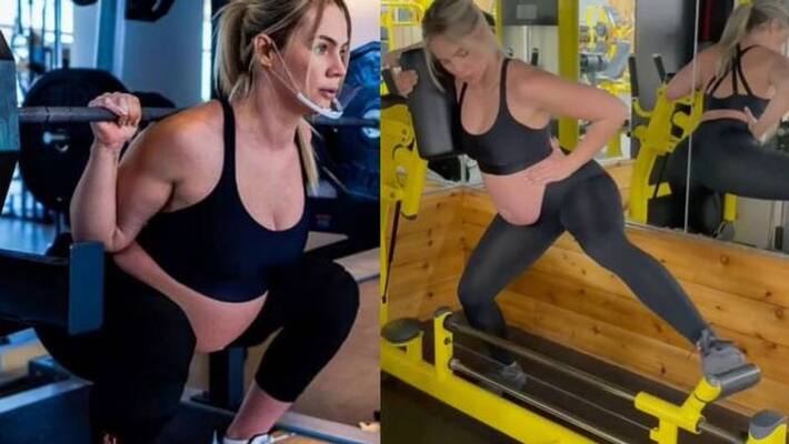 Pregnant fitness trainer is lifting weights Pregnant fitness trainer is lifting weights