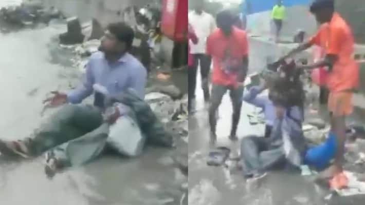 Shiv Sena MLA Dilip Lande forces a contractor to sit in a pile of garbage in mumbai bmm Shiv Sena MLA Dilip Lande forces a contractor to sit in a pile of garbage in mumbai bmm