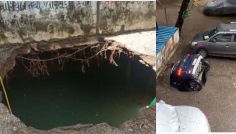 sinkhole swallowing a parked car at a housing society in Mumbais Ghatkopar