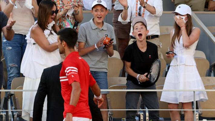 Novak Djokovic presents his title winning racquet and cap to small fan's after win the French Open 2021 spb Novak Djokovic presents his title winning racquet and cap to small fan's after win the French Open 2021 spb