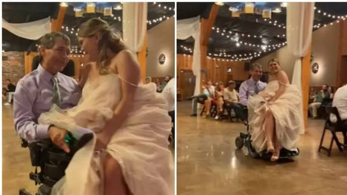 Daughter arrives at the wedding venue in a wheelchair on her father's lap Daughter arrives at the wedding venue in a wheelchair on her father's lap