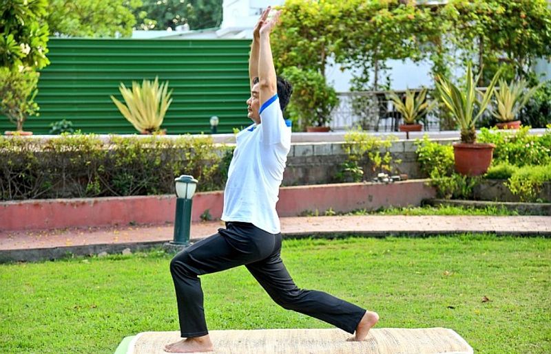 Union Minister of State for AYUSH, Youth Affairs and Sports Kiren Rijiju practices Yoga on the International Day of Yoga 2021.