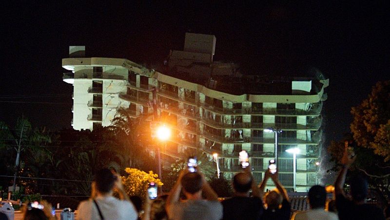 The unstable remains of the collapsed apartment block in Surfside, Florida were brought down late Sunday using a controlled explosion. The rest of the 12-story Champlain Towers South outside Miami was demolished shortly after 10:30 pm local time (8 am IST).