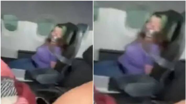 Woman is duct taped to chair after trying to open plane door midflight Woman is duct taped to chair after trying to open plane door midflight