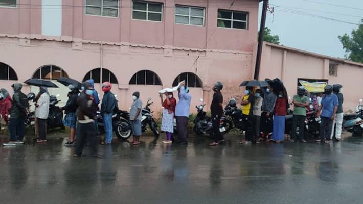 People standing on rain for corona vaccination at covai People standing on rain for corona vaccination at covai