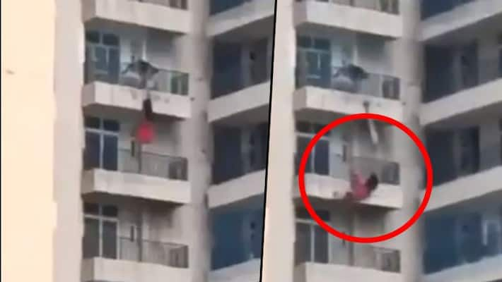 woman falling off building