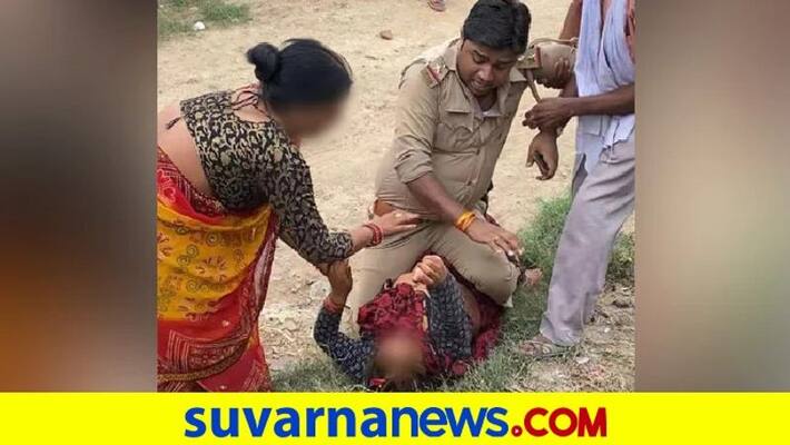Cop accused of beating woman sitting on top of her in UP Kanpur Dehat pod Cop accused of beating woman sitting on top of her in UP Kanpur Dehat pod