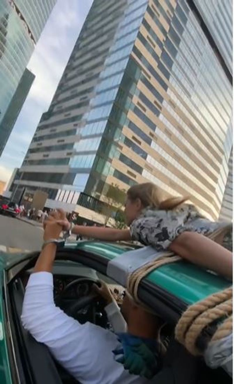 Man Drives With Girlfriend Tied To Roof In Bizarre 'Trust Test' In Russia