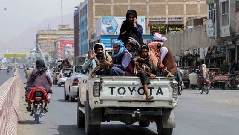 Taliban fighters throwing murdered victims in mass graves Daily Star report picture shows