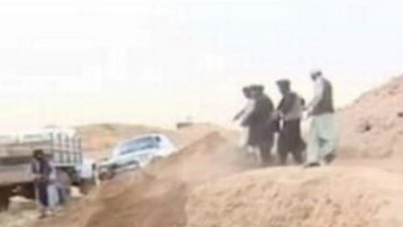 Taliban fighters throwing murdered victims in mass graves Daily Star report picture shows