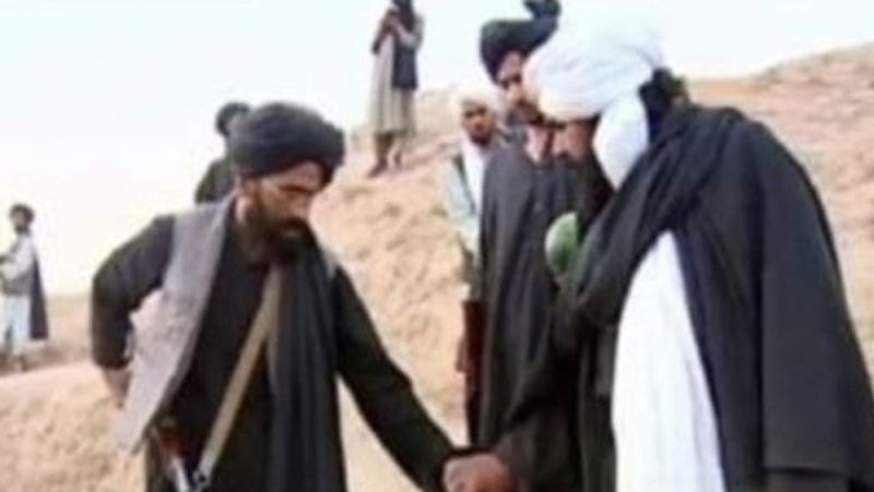 Taliban fighters throwing murdered victims in mass graves Daily Star report picture shows