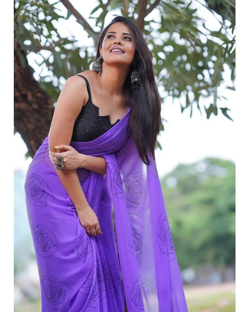Anasuya blue saree stunning photos dominating nature