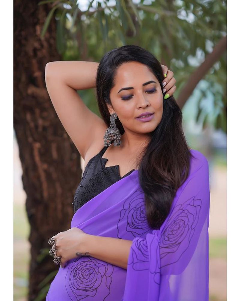 Anasuya blue saree stunning photos dominating nature