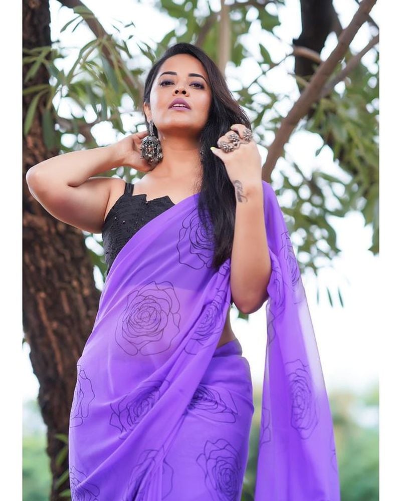 Anasuya blue saree stunning photos dominating nature