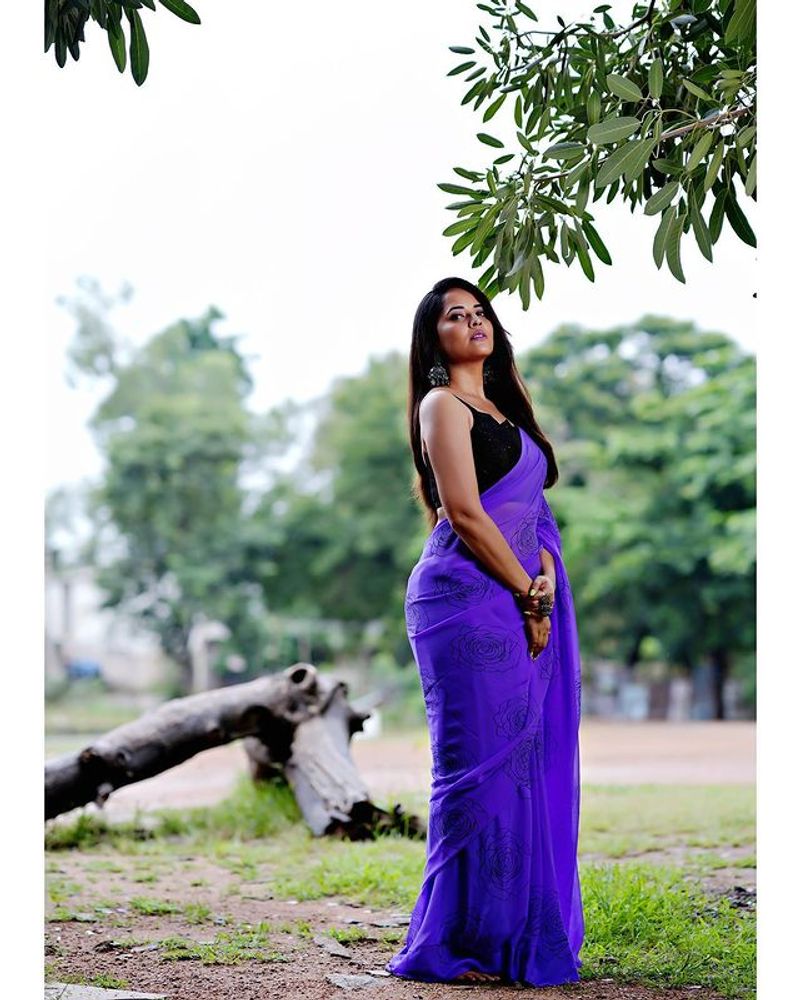Anasuya blue saree stunning photos dominating nature