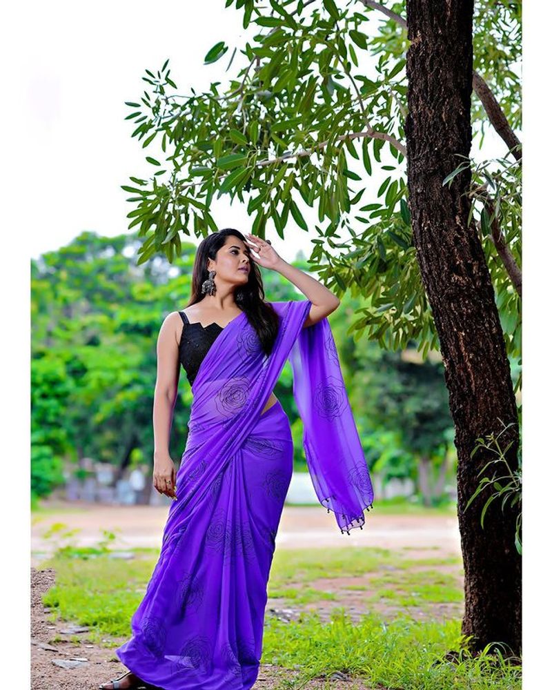 Anasuya blue saree stunning photos dominating nature