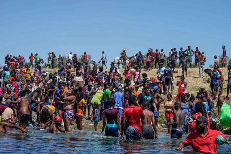 Shocking images of horse mounted US police officers whipping Haitian migrants on US Mexico border