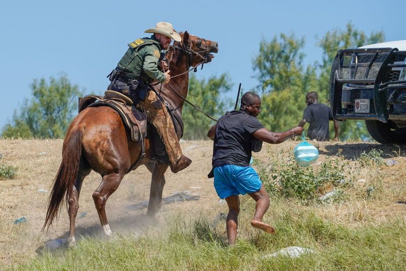 Shocking images of horse mounted US police officers whipping Haitian migrants on US Mexico border