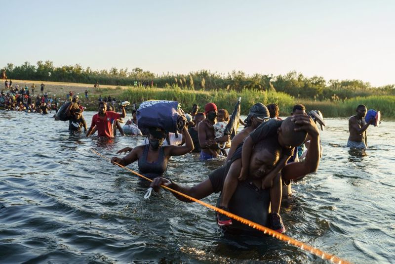 Shocking images of horse mounted US police officers whipping Haitian migrants on US Mexico border
