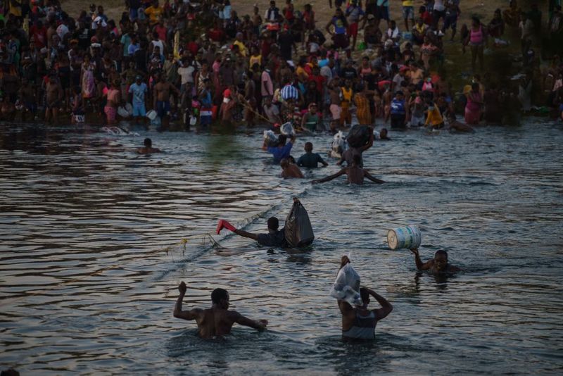 Shocking images of horse mounted US police officers whipping Haitian migrants on US Mexico border