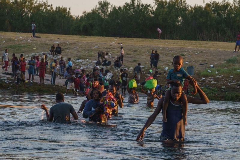 Shocking images of horse mounted US police officers whipping Haitian migrants on US Mexico border