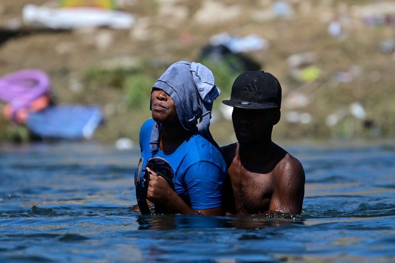 Shocking images of horse mounted US police officers whipping Haitian migrants on US Mexico border