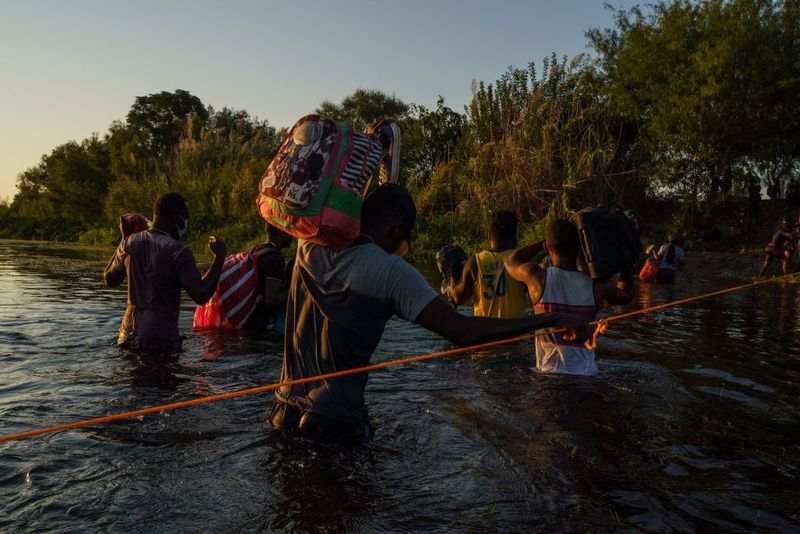 Shocking images of horse mounted US police officers whipping Haitian migrants on US Mexico border