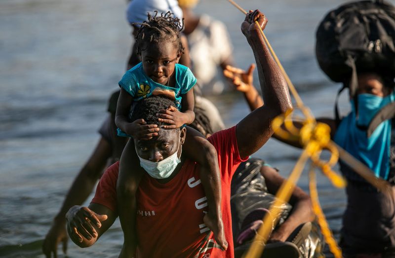 Shocking images of horse mounted US police officers whipping Haitian migrants on US Mexico border