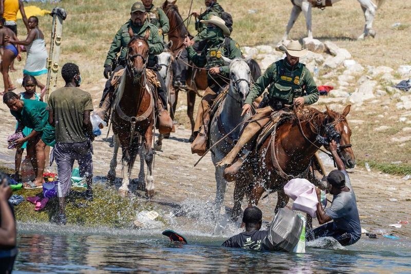 Shocking images of horse mounted US police officers whipping Haitian migrants on US Mexico border