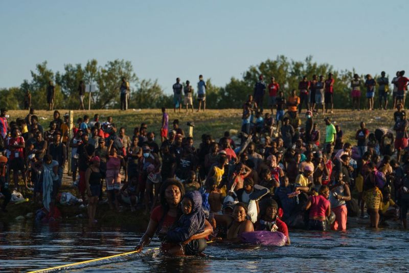 Shocking images of horse mounted US police officers whipping Haitian migrants on US Mexico border