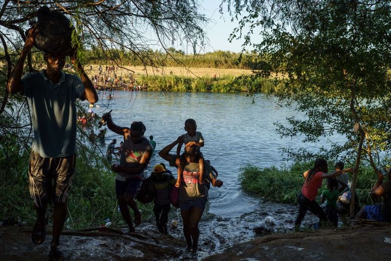 Shocking images of horse mounted US police officers whipping Haitian migrants on US Mexico border