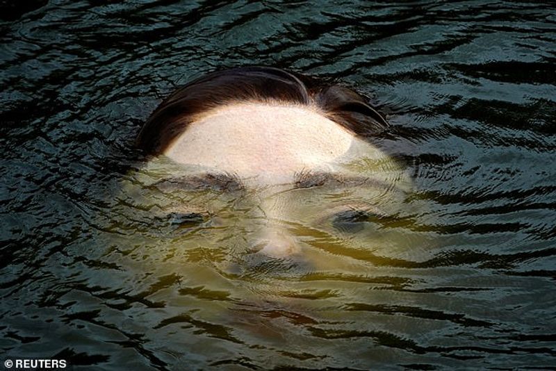 Sculpture of a girl drowning in the Bilbao River Controversial