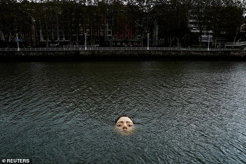 Sculpture of a girl drowning in the Bilbao River Controversial