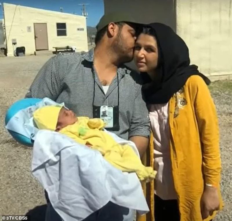 iconic photo baby lifted over wall at Kabul airport by Marine