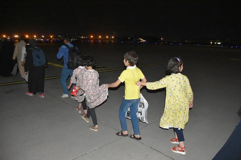 iconic photo baby lifted over wall at Kabul airport by Marine