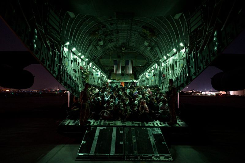 iconic photo baby lifted over wall at Kabul airport by Marine