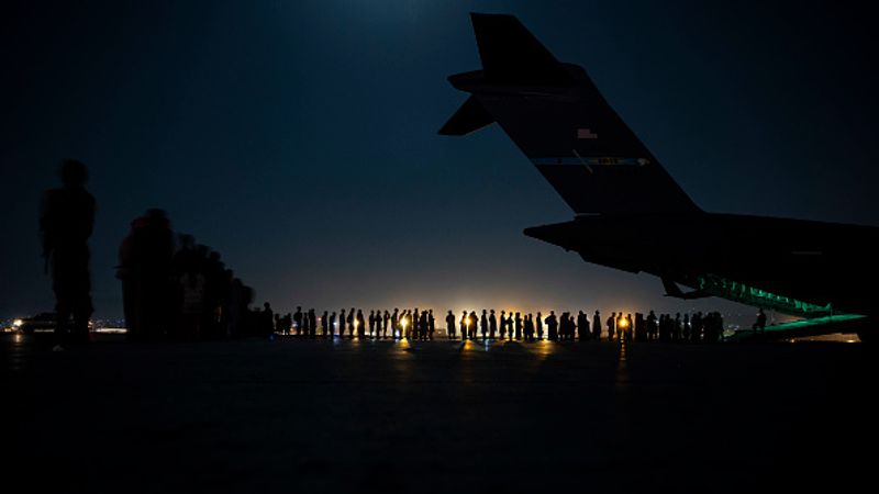 iconic photo baby lifted over wall at Kabul airport by Marine
