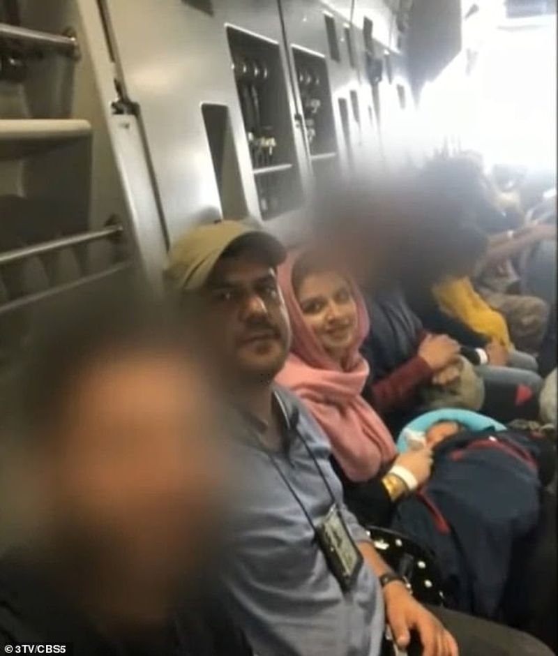 iconic photo baby lifted over wall at Kabul airport by Marine