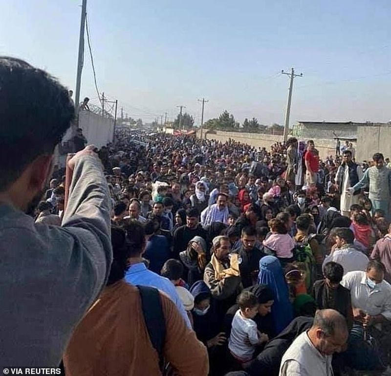 iconic photo baby lifted over wall at Kabul airport by Marine