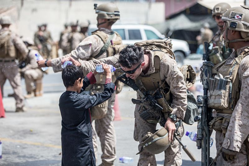 iconic photo baby lifted over wall at Kabul airport by Marine