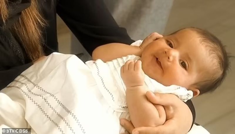 iconic photo baby lifted over wall at Kabul airport by Marine